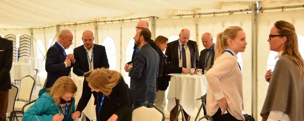 Several small groups of people networking at SIF Oceans