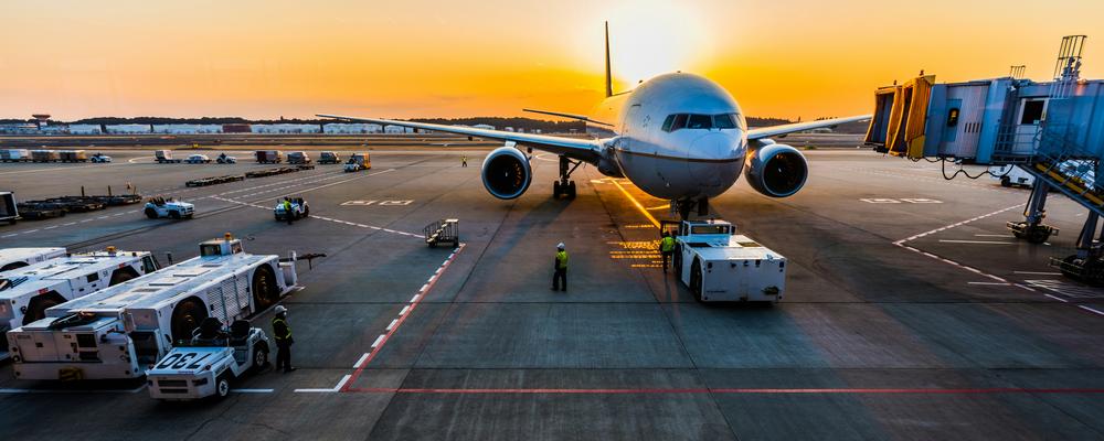 A plane at an airport waiting to departure.