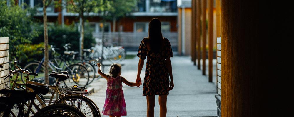 Mother and child walking hand in hand to a brighter future.