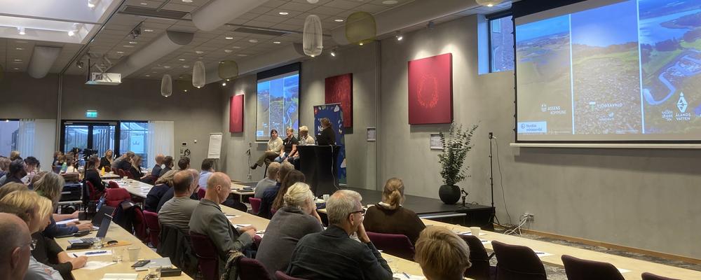 Conference room with participants and speakers